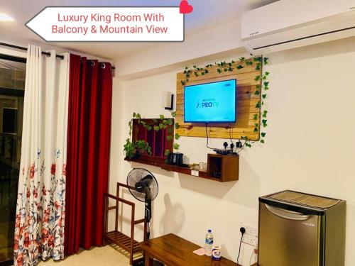 a living room with a television on a wall at The Rock Face in Ella