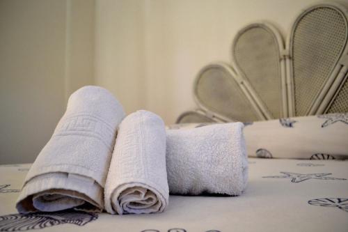two towels sitting on top of a bed at Porticciolo in San Vito
