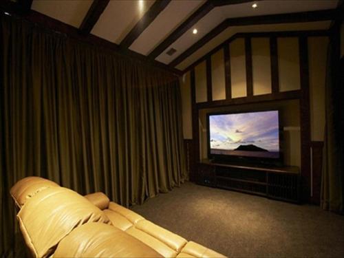 a bedroom with a bed and a tv in a room at Unzen Kanko Hotel in Unzen