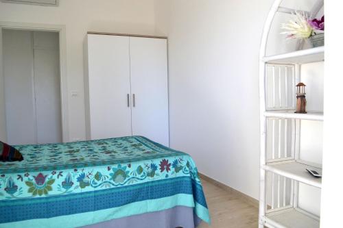 a bedroom with a bed and a white cabinet at Porticciolo in San Vito