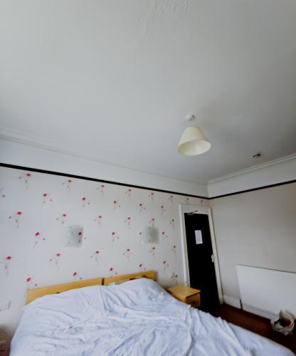 a bedroom with a bed and a wall with stars at Station Hotel Portsoy in Portsoy