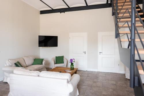 a living room with a white couch and a table at Storchenhof Blumenow in Blumenow