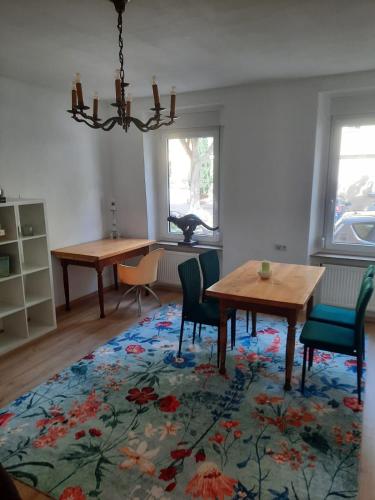 a dining room with a table and chairs on a rug at Apartment in Bayreuth in Niederdorla