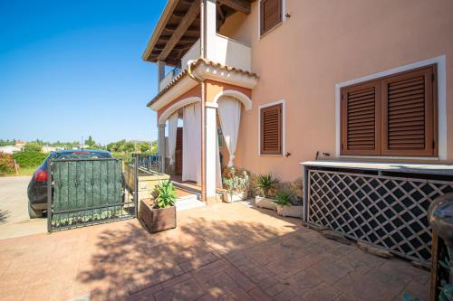 a house with a gate and a patio at Casa delle Sorgenti 2 in Torpè