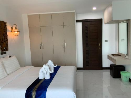 a hotel room with a bed with towels on it at Lemon Guesthouse in Chiang Mai