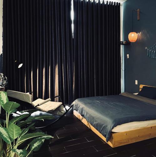 a bedroom with a bed and a black curtain at Khế Homestay in Can Tho
