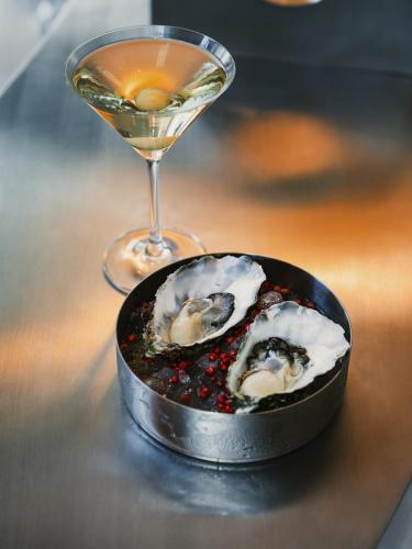 a plate of oysters and a glass of wine at The Standard, Brussels in Brussels