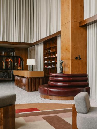 a lobby with a wine cellar and a table and chairs at The Standard, Brussels in Brussels