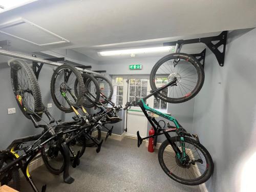 two bikes are hanging on a rack in a room at Gwesty Seren Hotel in Blaenau-Ffestiniog