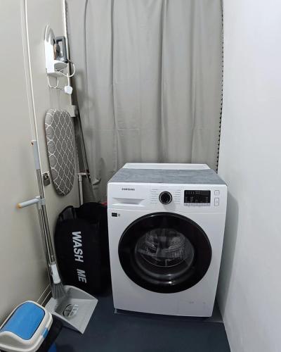 a washing machine is sitting in a room at 8 Paddy Escape Alor Setar, INS-Style, 3R 1B1T, Kid Toys, Bikes Rent in Simpang Empat