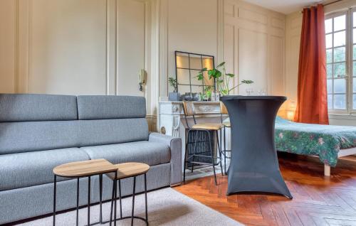 a living room with a couch and a table at Cozy Apartment In Les Andelys With Wifi in Les Andelys