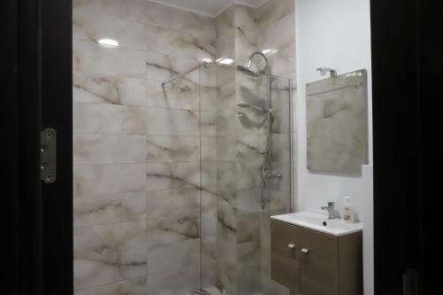 a bathroom with a shower and a sink at Maryon in Constanţa