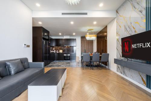 a living room with a couch and a dining room at Lumiere Horizon Suites in Ho Chi Minh City