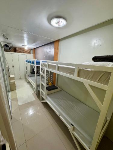 a room with several bunk beds in a room at M & D Rentals by Jick in Butuan