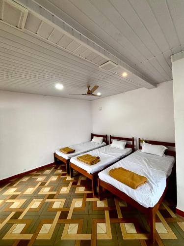 a room with two beds and a ceiling at Siddhi Farm Kolad in Kolād