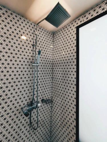 a shower in a bathroom with a tile wall at Светлые апартаменты Royal Lee in Ban Bo Han