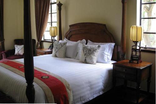 a bedroom with a large bed with white sheets and pillows at Kevin's Old House in Shanghai