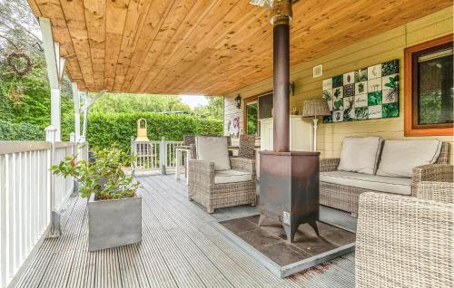 a porch with a wood ceiling and a wood stove at 2 Bedroom Beautiful Home In Erm in Erm