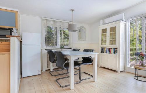 a kitchen with a table and chairs and a refrigerator at 2 Bedroom Beautiful Home In Erm in Erm