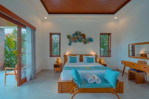 a bedroom with a bed and a desk and windows at Matahari Lumbung Resort in Ubud