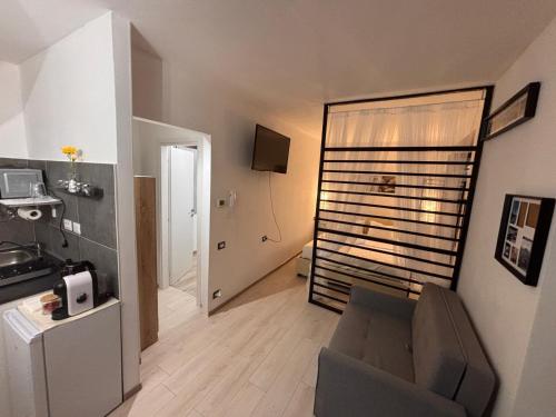 a living room with a chair and a door to a room at Casa LuJho in Brivio