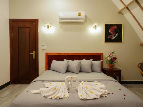 Ένα ή περισσότερα κρεβάτια σε δωμάτιο στο Bali Villa Kampot Resort