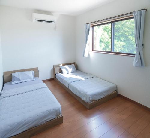 Postel nebo postele na pokoji v ubytování Links seaside resort -ビーチまで徒歩1分&サウナ完備-