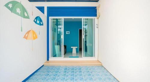 a bathroom with an open door with a toilet at Paragon Hometel in Surat Thani