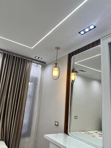 a mirror and lights in a room with a window at LuXURY STUDIOS MATROUH 2 in Marsa Matruh