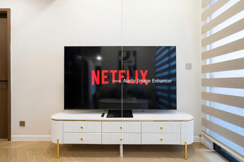 a tv sitting on top of a white entertainment center at Lumiere Horizon Suites in Ho Chi Minh City