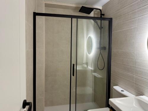 a shower with a glass door in a bathroom at Sindical in Castellón de la Plana
