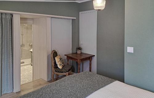 a bedroom with a bed and a table and a desk at Beautiful Home In Thierville With Wifi in Thierville