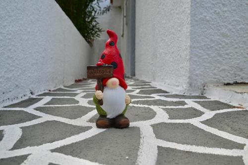 a figurine of a cardinal standing on a street at Rastoni Apartments Skiathos in Troulos
