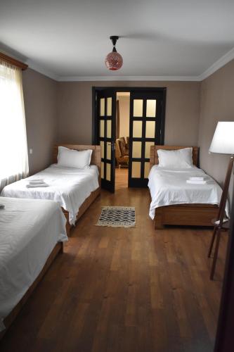 a room with two beds and a mirror at Mtskheta Apartment 158 in Mtskheta