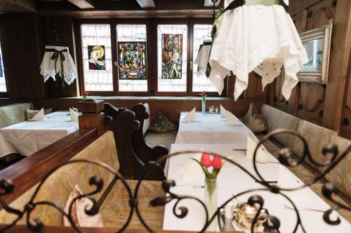 a restaurant with two tables and a dress hanging from the ceiling at Hotel Traube in Stuttgart