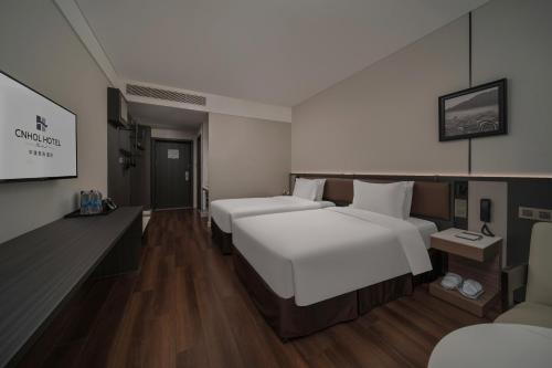 Cama o camas de una habitación en CNHOL RADIENT HOTEL Dongguan Humen
