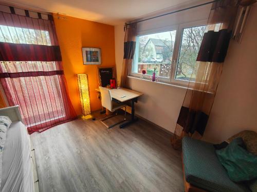 a room with a desk and a window and a bed at Zimmer oberhalb einer Schokoladenfabrik in Kreuzlingen