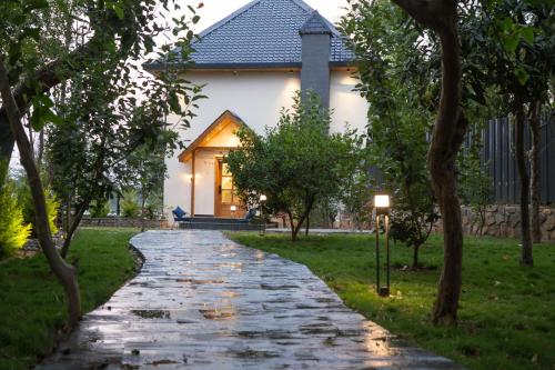 a cobblestone path in front of a house at Maple house Hillside 3-BHK Without Pvt Pool & Open Pizzeria in Kangra