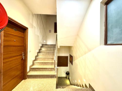 a staircase in a building with a wooden door at Hotel Bahl Regency in Zirakpur