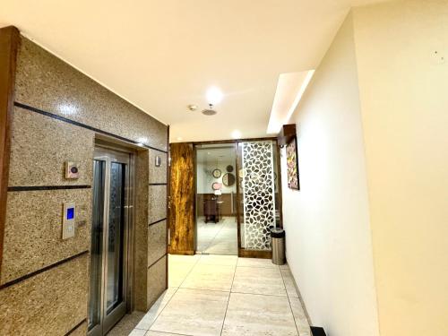 a hallway with a door leading into a room at Hotel Bahl Regency in Zirakpur