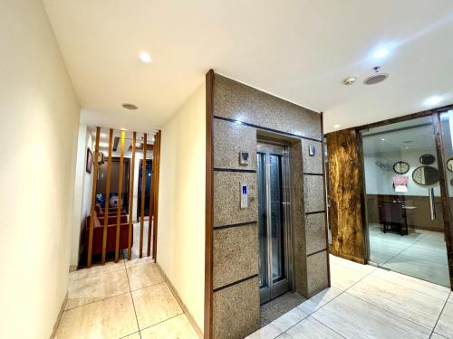 a hallway with two elevators in a building at Hotel Bahl Regency in Zirakpur