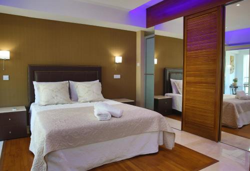 a bedroom with a large bed with white sheets at Sofouli Suites in Nicosia