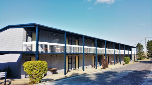 a building with a blue and white building at Snow Season Motor Inn in Cooma