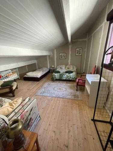 a living room with two beds in a room at Sac des Vertues Bordure Rivière in Beaumont-sur-Sarthe