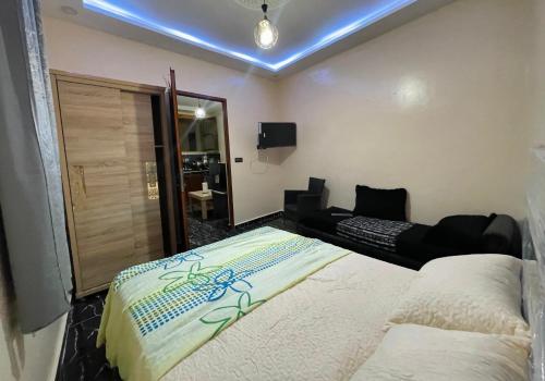 a bedroom with a bed and a living room at Cozy Tamri Apartment Nature, Calm , Comfort in Tamri