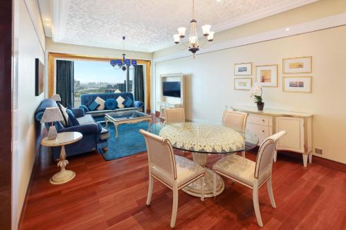 a living room with a table and chairs at The Reverie Saigon Residential Suites in Ho Chi Minh City