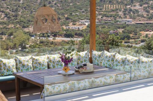 a room with a couch and a table with a view at Sunny Drops Villas by Estia in Balíon