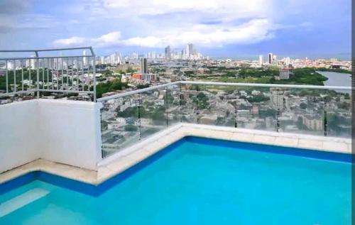 a swimming pool on top of a building with a city at B experience cartagena bolívar in Cartagena de Indias