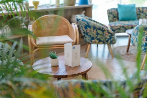 a table with a sign on it in a room with chairs at Les Bulles de Mer - Hotel & Spa sur la Plage in Saint-Cyprien