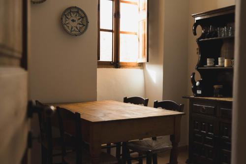 a dining room table with chairs and a clock on the wall at Finca Can Estades in Calvia Town